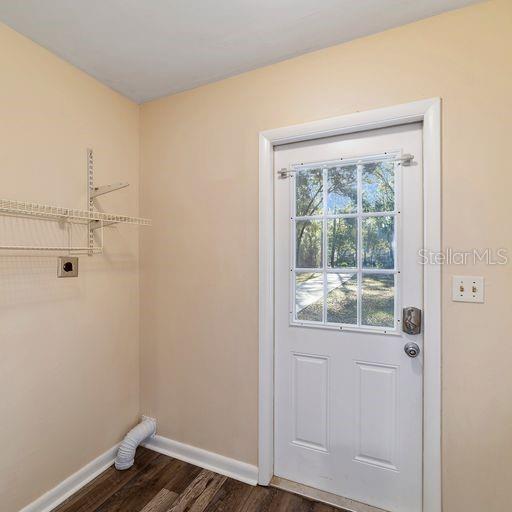 doorway to outside with dark hardwood / wood-style flooring