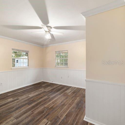 spare room with ceiling fan, dark wood-type flooring, and crown molding