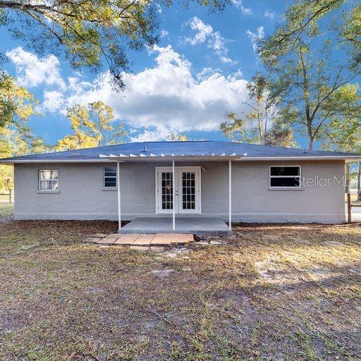 back of property featuring french doors and a patio area