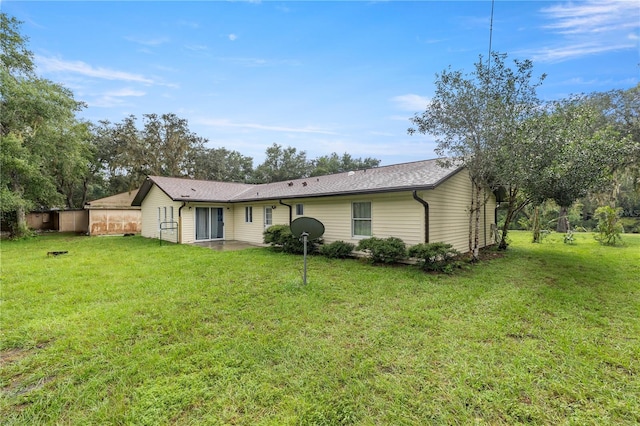 rear view of property with a yard