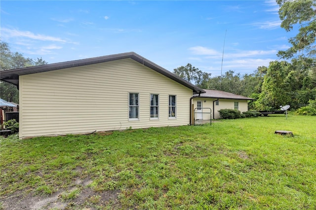 rear view of property with a lawn