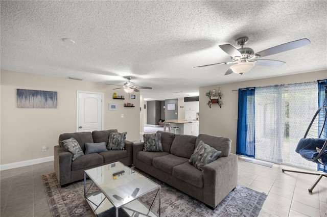 tiled living room with a textured ceiling and ceiling fan