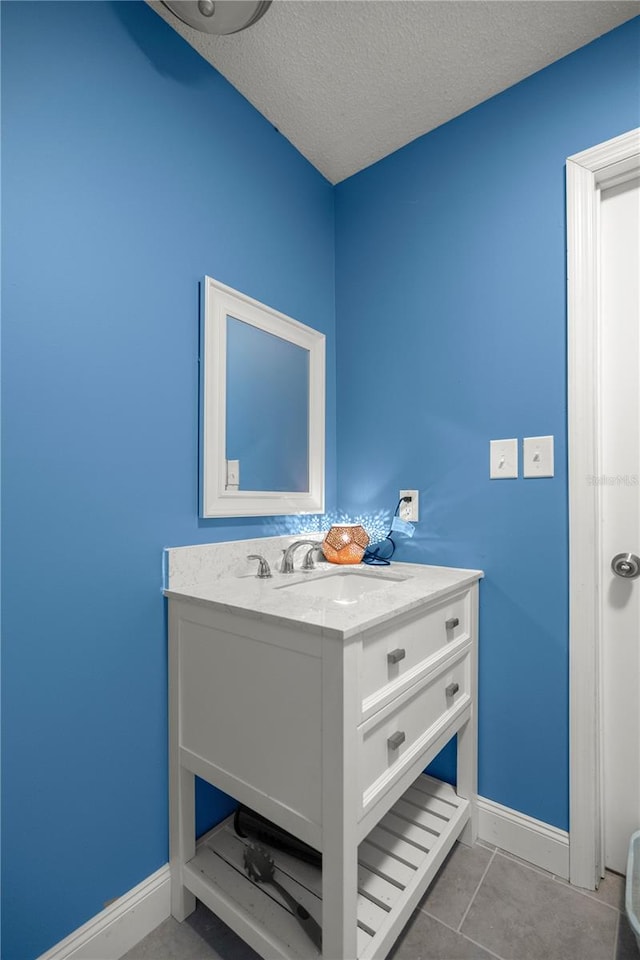 bathroom featuring tile patterned floors, a textured ceiling, and vanity