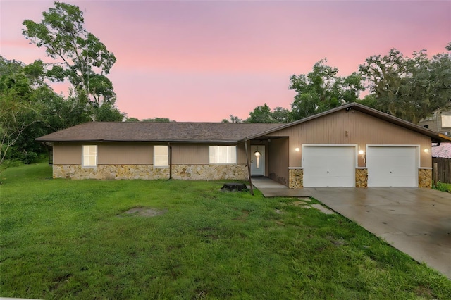 ranch-style house with a lawn and a garage