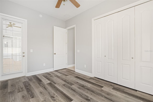 unfurnished bedroom featuring a closet, wood-type flooring, and ceiling fan