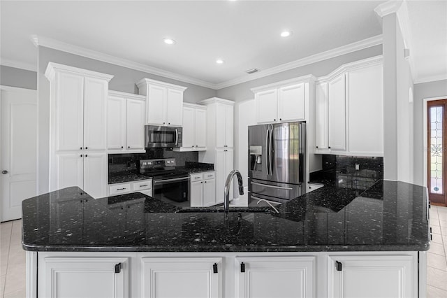 kitchen featuring crown molding, appliances with stainless steel finishes, light tile patterned floors, and dark stone countertops