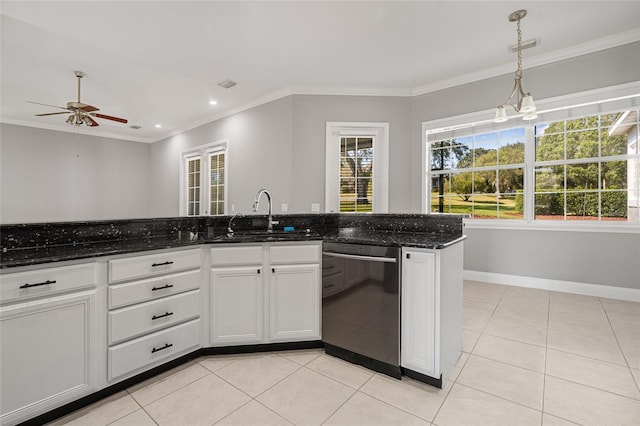 kitchen featuring dishwasher, sink, white cabinetry, pendant lighting, and dark stone countertops