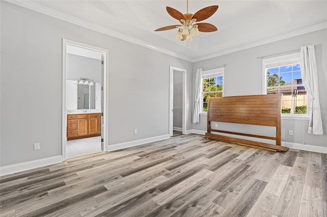 interior space featuring ornamental molding, light hardwood / wood-style flooring, and ceiling fan