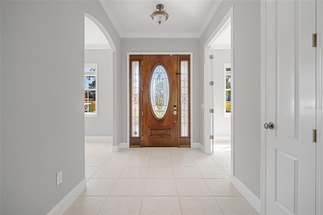 entryway featuring crown molding and light tile patterned floors