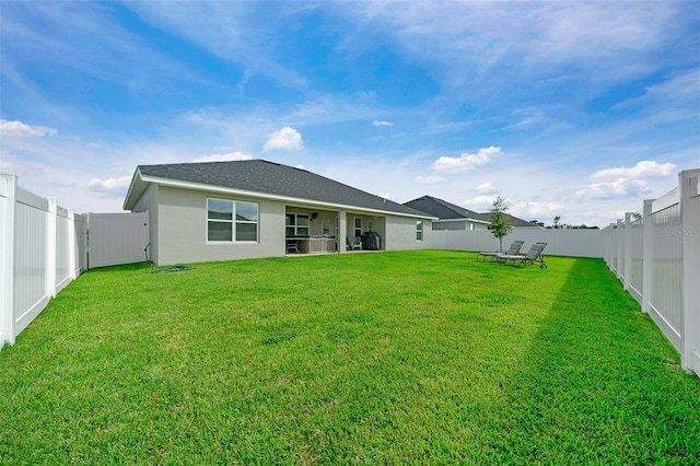 rear view of house with a lawn