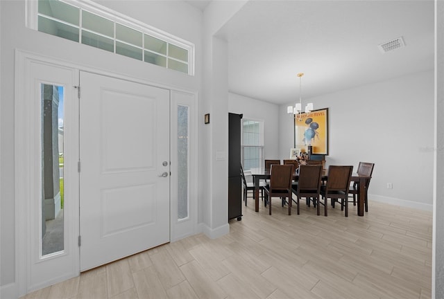 entryway with a chandelier and light hardwood / wood-style floors