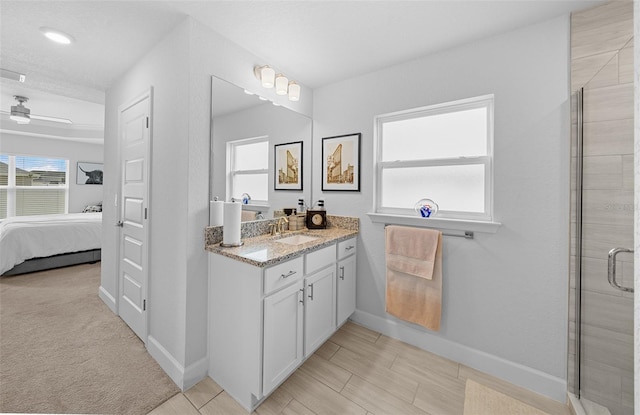 bathroom with ceiling fan, vanity, and a shower with shower door