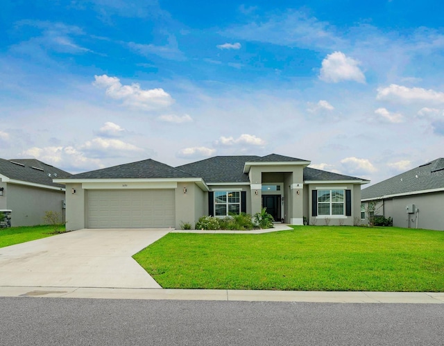 view of front of home featuring a garage and a front lawn