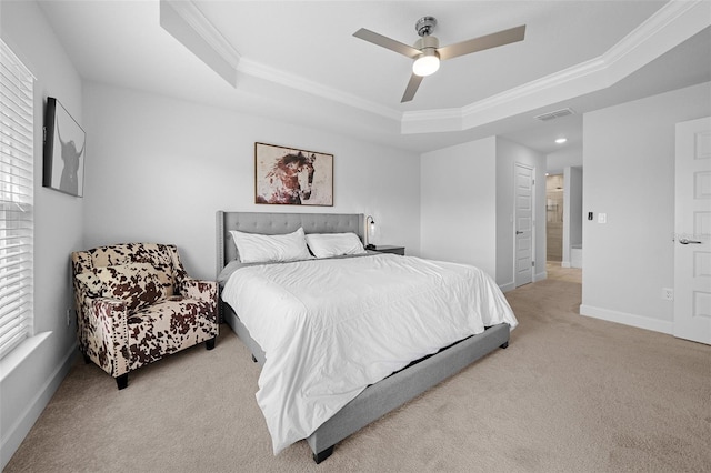 bedroom featuring a raised ceiling, ceiling fan, and crown molding