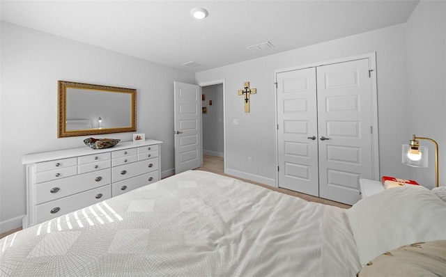 bedroom featuring a closet and light hardwood / wood-style flooring