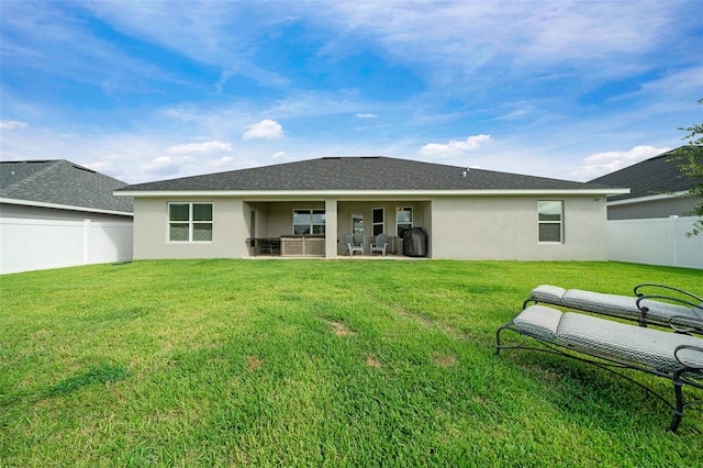 back of property featuring a yard and a patio area