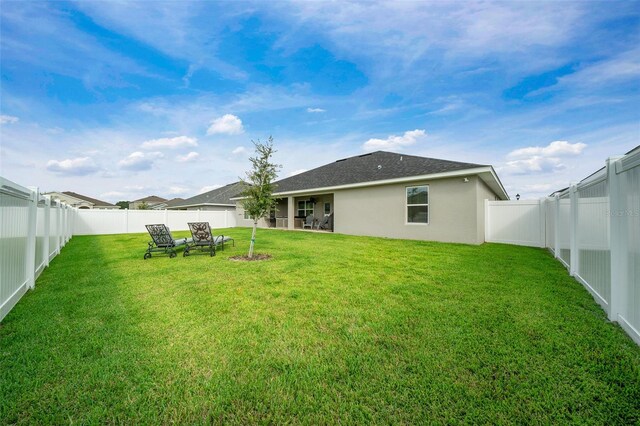 back of house featuring a yard