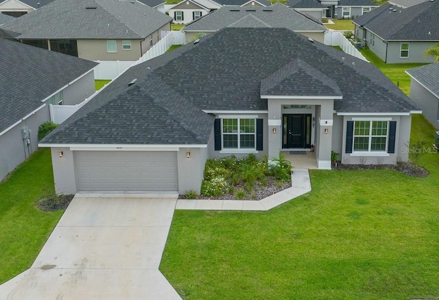 view of front of home featuring a garage and a front yard