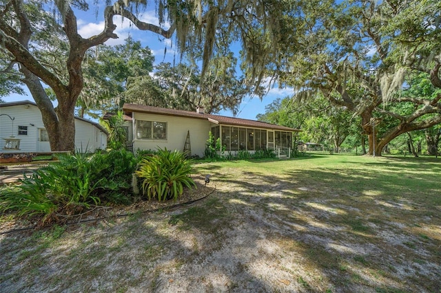 view of yard featuring a sunroom