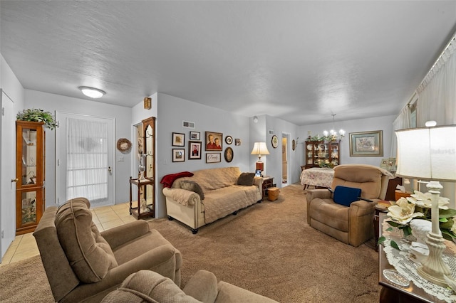 living room featuring a textured ceiling, light tile patterned flooring, and a notable chandelier