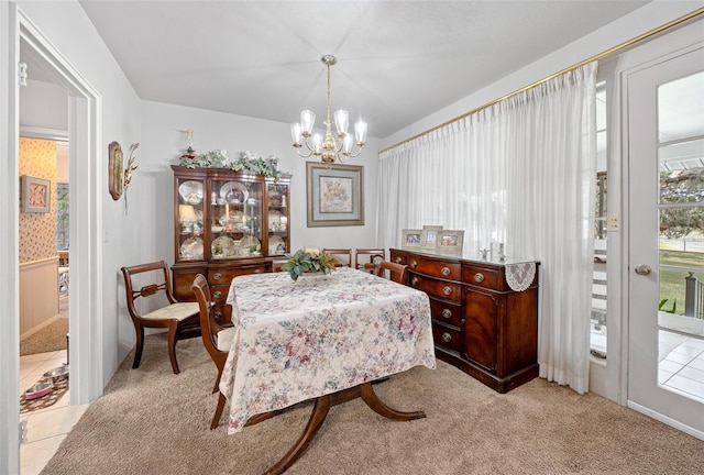 dining room featuring an inviting chandelier and light colored carpet