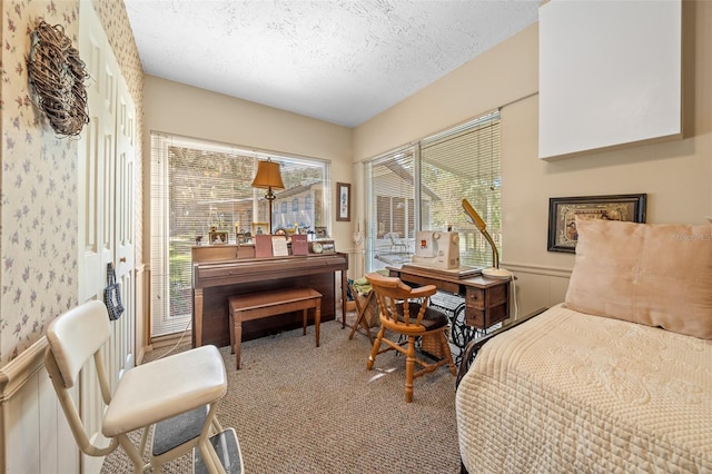 carpeted bedroom featuring a textured ceiling