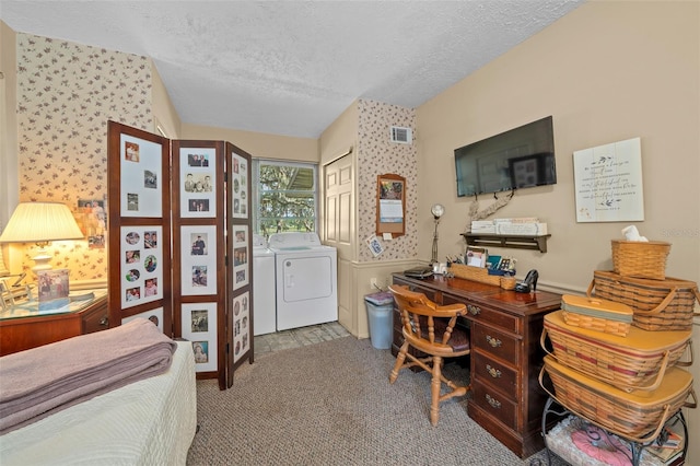 carpeted office featuring a textured ceiling and washing machine and dryer