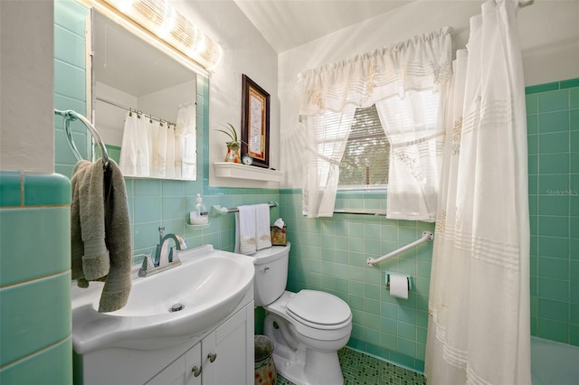 bathroom with vanity, tile walls, toilet, and a shower with shower curtain