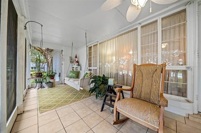 sunroom / solarium featuring ceiling fan