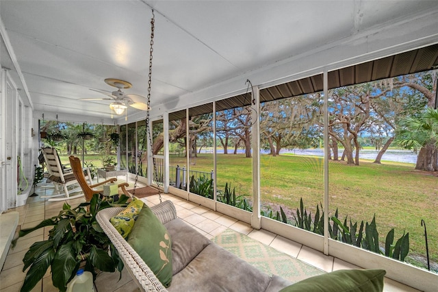 unfurnished sunroom with ceiling fan