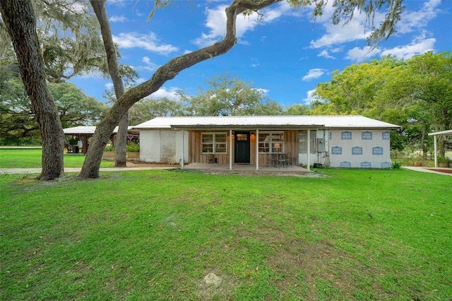 back of property featuring a lawn