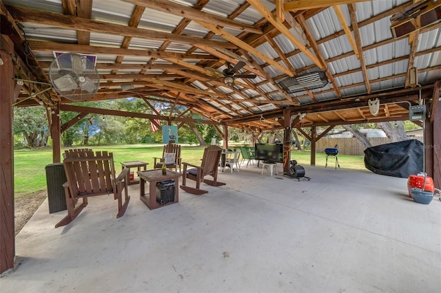 view of patio featuring ceiling fan, a gazebo, and a fire pit