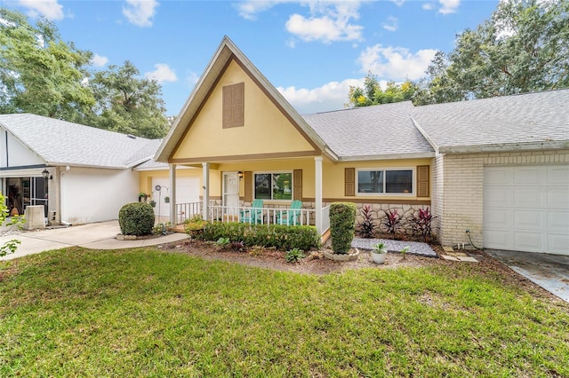 view of front of house featuring a porch, a garage, and a front lawn