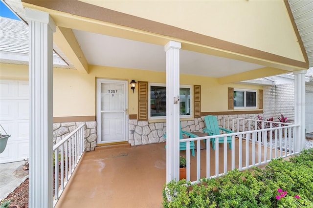 view of patio with a porch and a garage