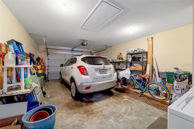 garage with a garage door opener and washer / dryer