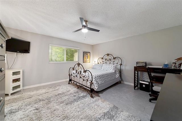 bedroom with a textured ceiling and ceiling fan