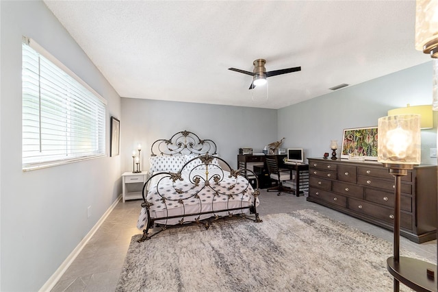 bedroom featuring ceiling fan and a textured ceiling