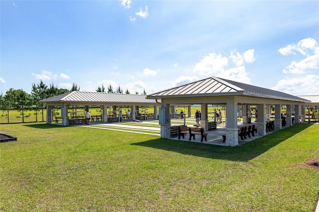 view of property's community with a lawn and a gazebo