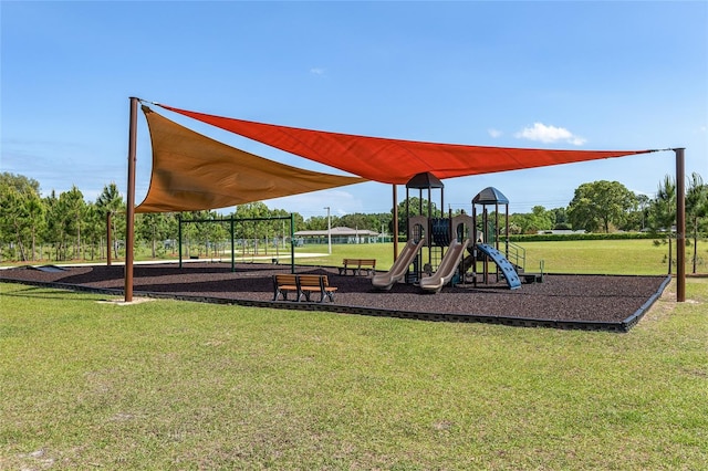 view of jungle gym featuring a lawn