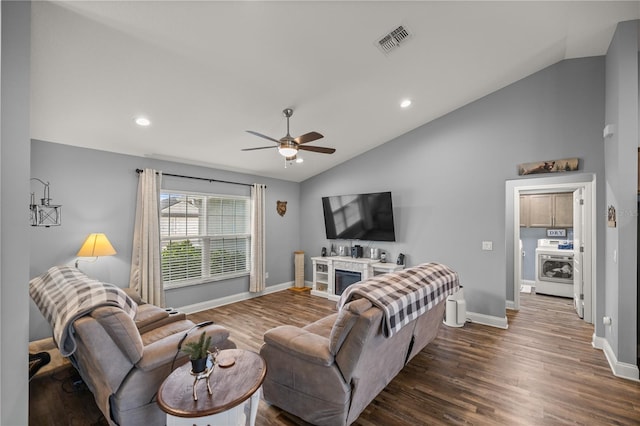 living room with ceiling fan, vaulted ceiling, and dark hardwood / wood-style flooring