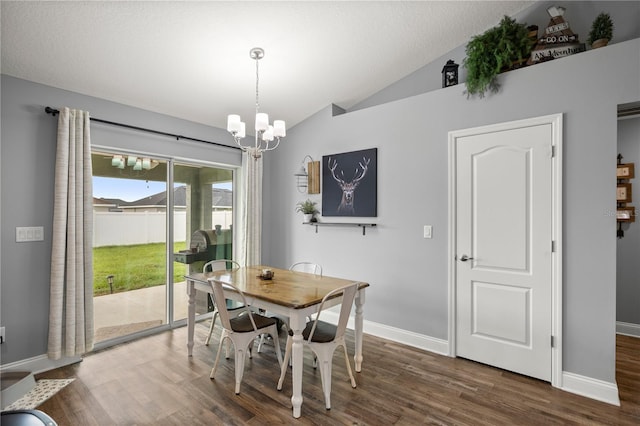 dining space with an inviting chandelier, lofted ceiling, and dark hardwood / wood-style floors