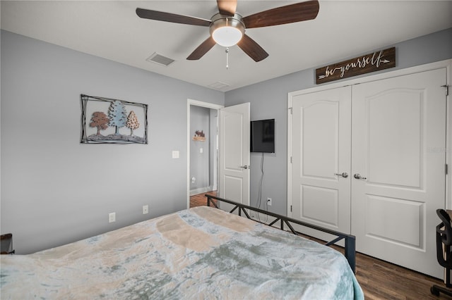 unfurnished bedroom with ceiling fan, a closet, and dark wood-type flooring