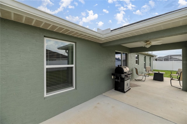 view of patio with ceiling fan and a grill