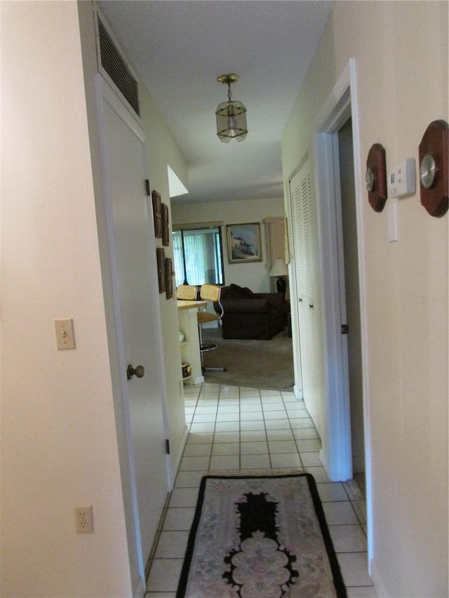 hall with light tile patterned floors