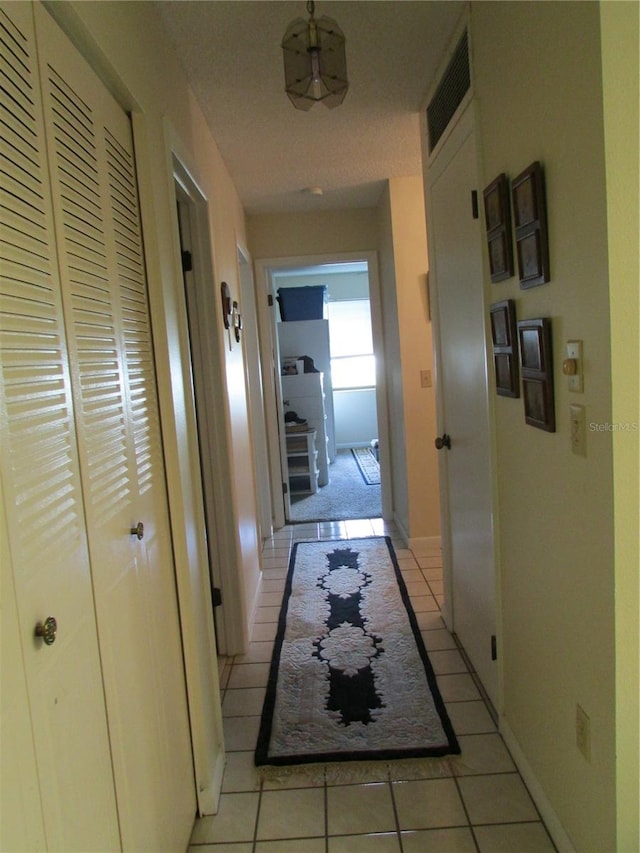 corridor featuring light tile patterned flooring