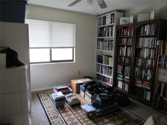 misc room featuring light colored carpet and ceiling fan