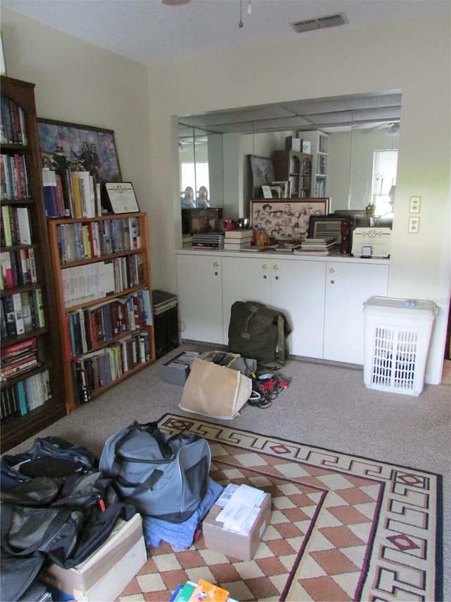 interior space featuring ceiling fan and light carpet