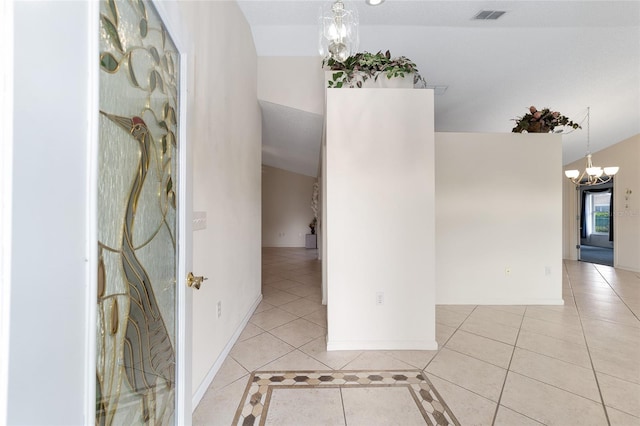 interior space with light tile patterned flooring, lofted ceiling, and a chandelier