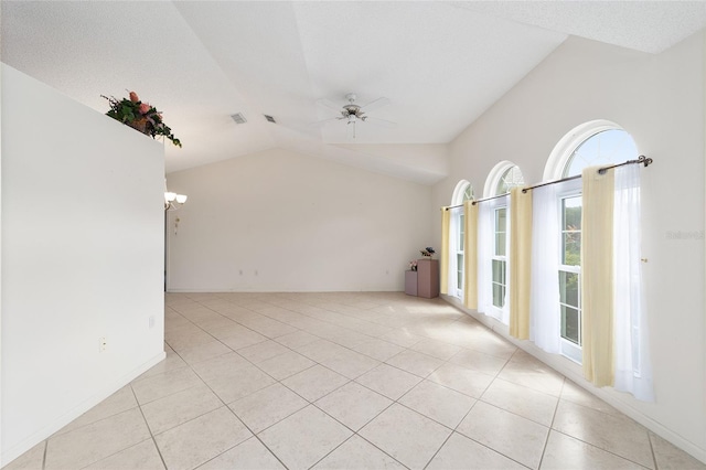 tiled spare room featuring ceiling fan with notable chandelier, a textured ceiling, and lofted ceiling