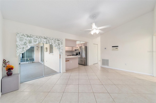 unfurnished living room with ceiling fan and light tile patterned floors